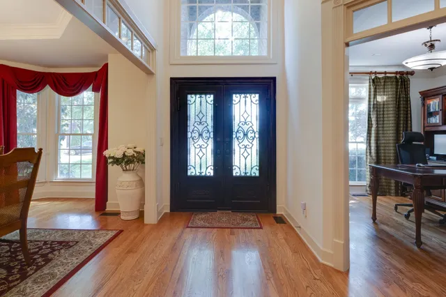 a view of entryway with a window and wooden floor