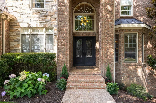 a front view of a house with a garden