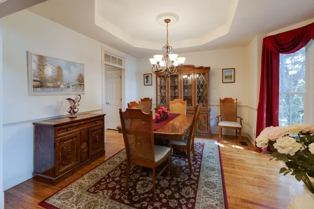 a view of a dining room with furniture and chandelier