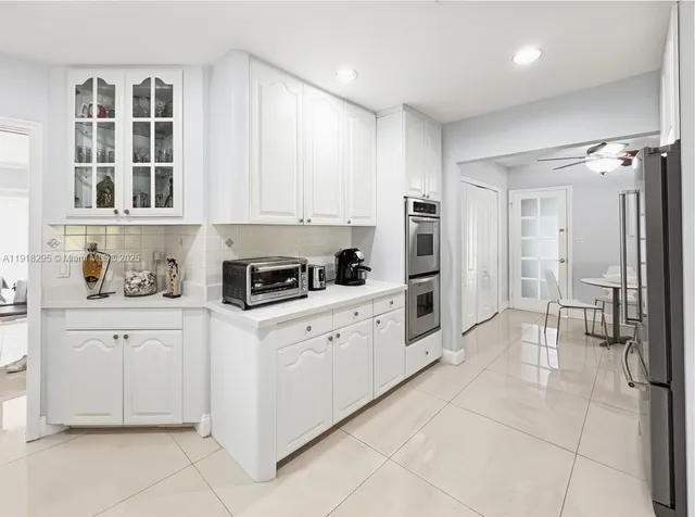 a view of a room that has a table and chairs in it