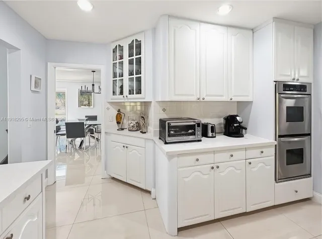 a kitchen with stainless steel appliances a sink and a refrigerator