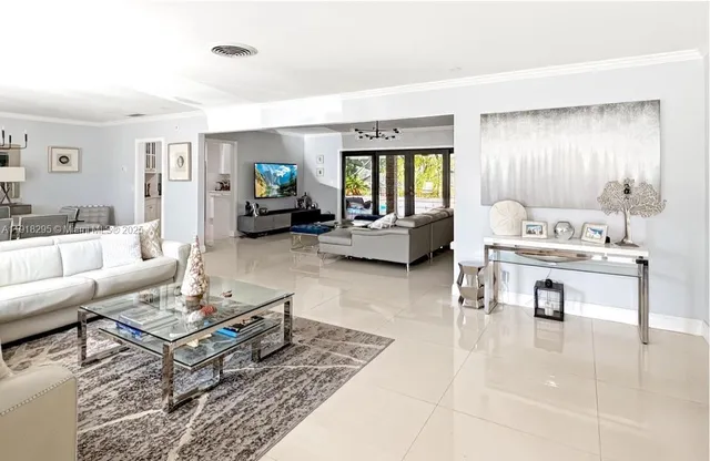 a living room with furniture and large windows