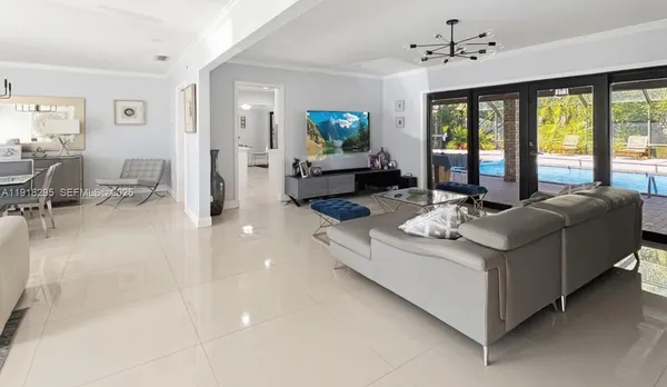 a view of a hallway with entryway door chandelier and front door