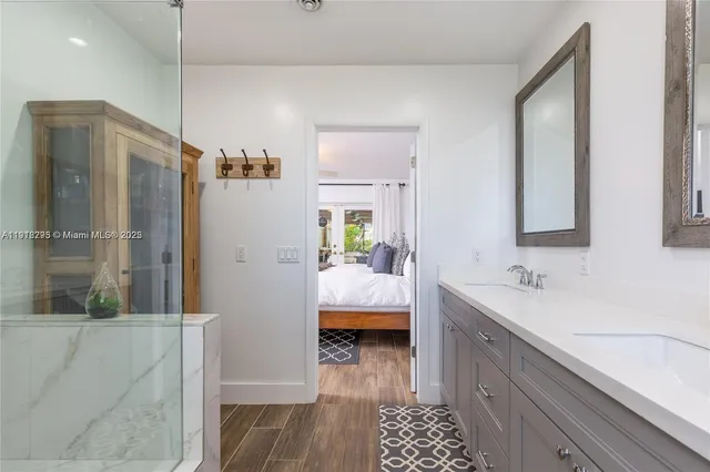 a spacious bathroom with a double vanity sink a mirror and a