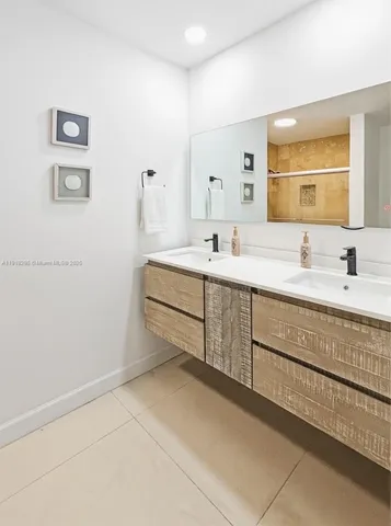 a utility room with stainless steel appliances granite countertop a stove a microwave a refrigerator and a window