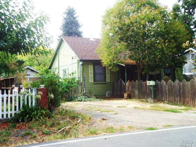 Fenced in yard, front and back. Gate to back unattached garage/studio has room for more parking behind gate. Newer roof! Lots of parking and room for RV.