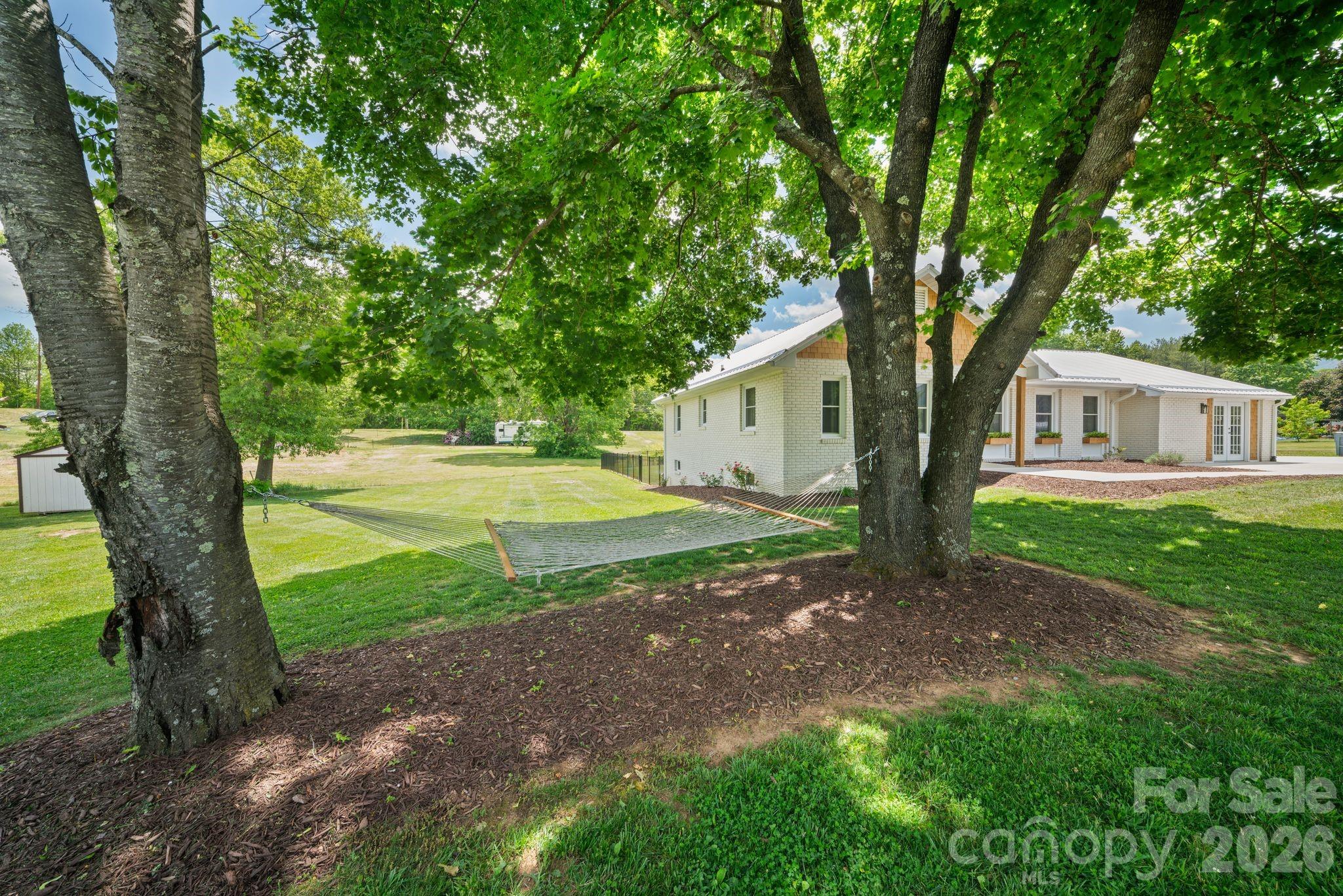 97 Paul Holland Road Canton, NC 28716 - Photo 7 of 35 a view of a house with backyard and a tree