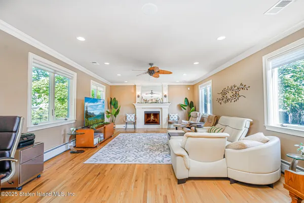 an empty room with wooden floor and natural light
