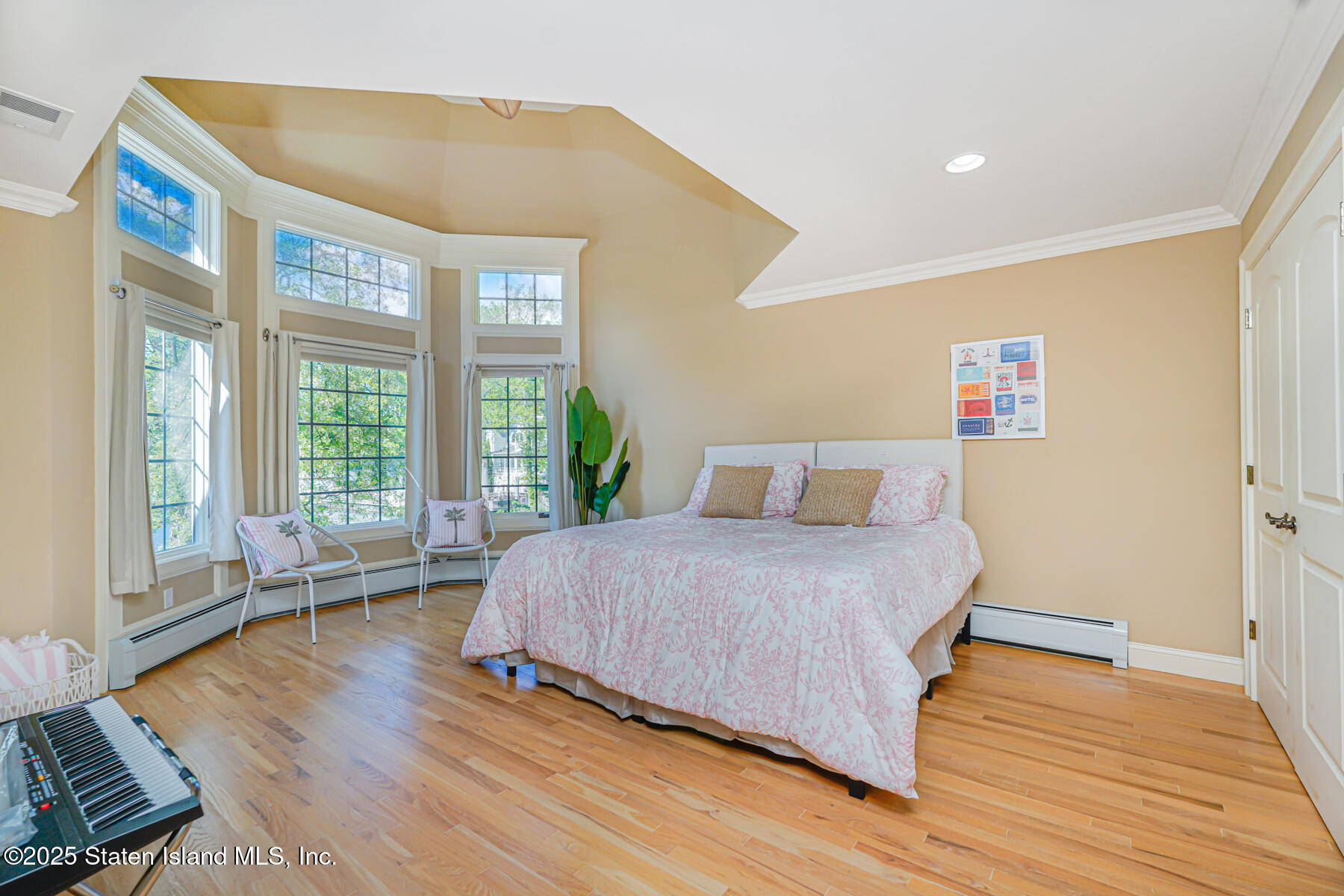 66 Normalee Road Staten Island, NY 10305 - Photo 26 of 54 a bedroom with a bed and wooden floor