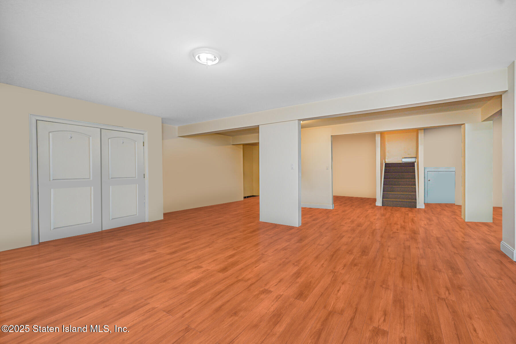 66 Normalee Road Staten Island, NY 10305 - Photo 34 of 54 a view of an empty room with wooden floor and a window