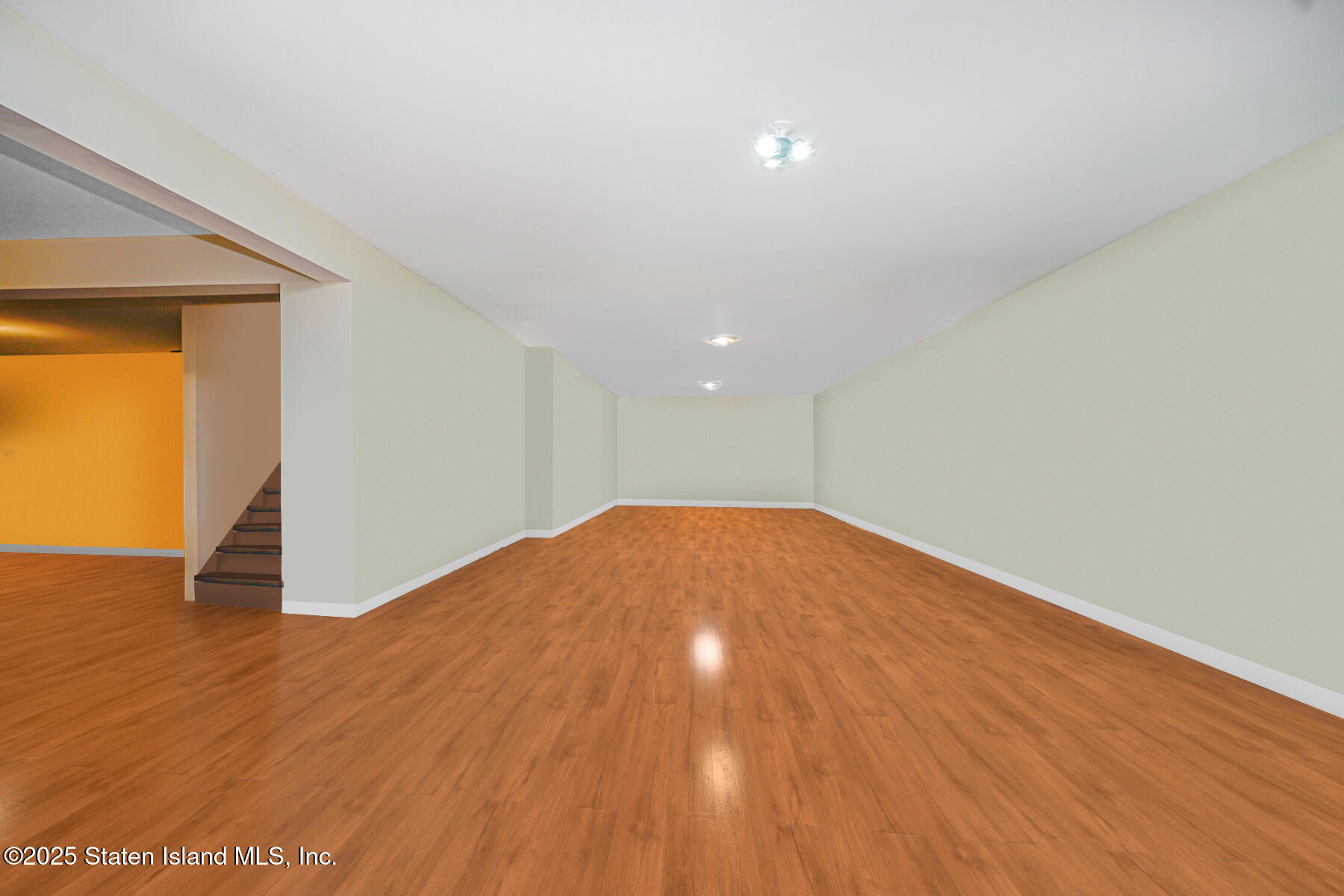66 Normalee Road Staten Island, NY 10305 - Photo 35 of 54 an empty room with wooden floor and natural light