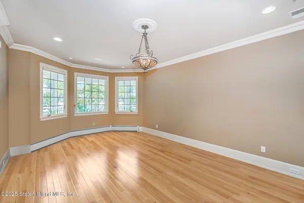 a kitchen with stainless steel appliances kitchen island granite countertop a table chairs sink and cabinets