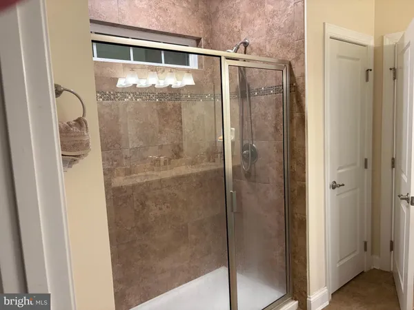 a bathroom with a glass shower door