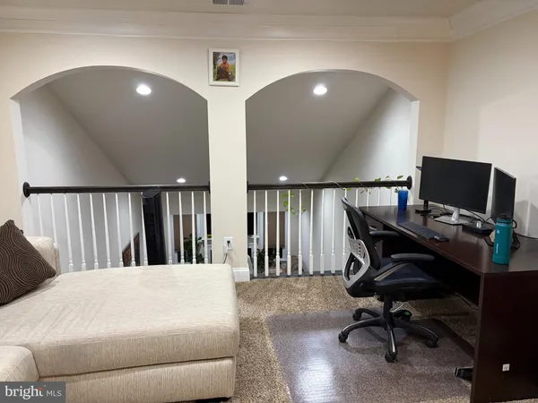 a workspace with a white couch