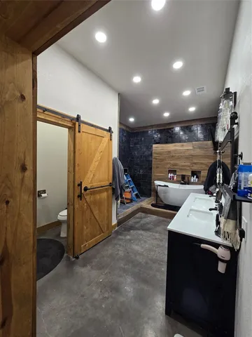 a view of a refrigerator in kitchen and utility room