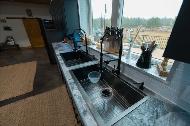 a kitchen with refrigerator and chairs