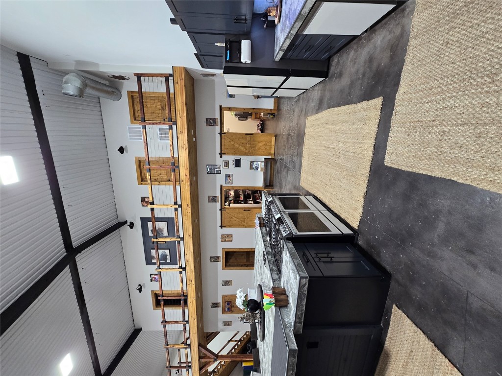 143 County Road Paige, TX 78659 - Photo 25 of 36 a large kitchen with stainless steel appliances granite countertop a lot of cabinets and wooden floor
