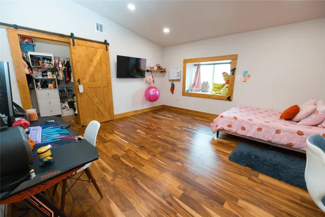 a spacious bathroom with a mirror and a shower