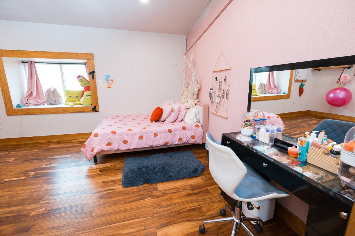 143 County Road Paige, TX 78659 - Photo 9 of 36 a bedroom with a bed and wooden floor