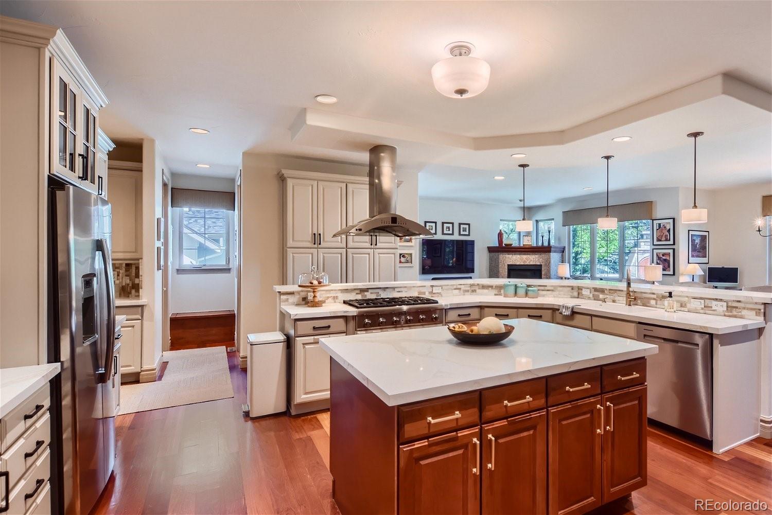 722 Skywalker Point Lafayette, CO 80026 - Photo 12 of 47 a kitchen with a stove a sink a refrigerator and wooden floor