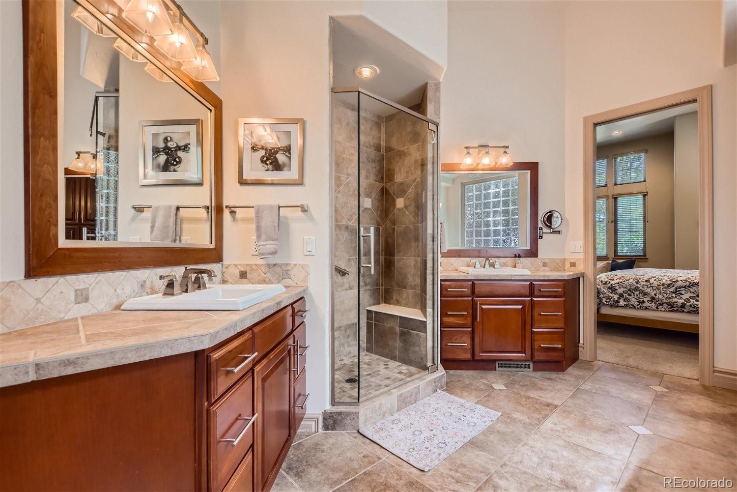 722 Skywalker Point Lafayette, CO 80026 - Photo 16 of 47 a spacious bathroom with a double vanity sink and a mirror