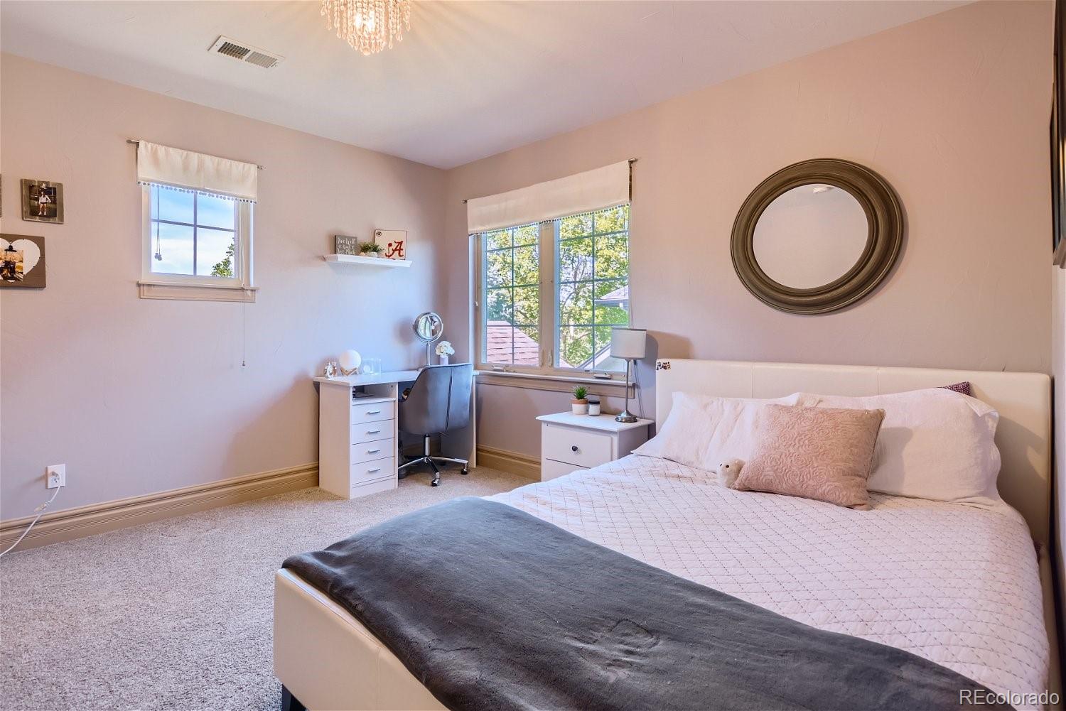 722 Skywalker Point Lafayette, CO 80026 - Photo 20 of 47 a bedroom with a bed and a chandelier