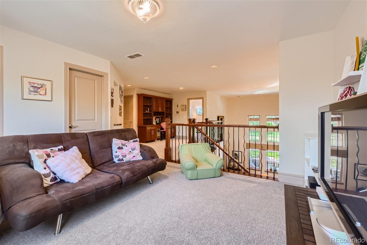 722 Skywalker Point Lafayette, CO 80026 - Photo 23 of 47 a living room with furniture and a table