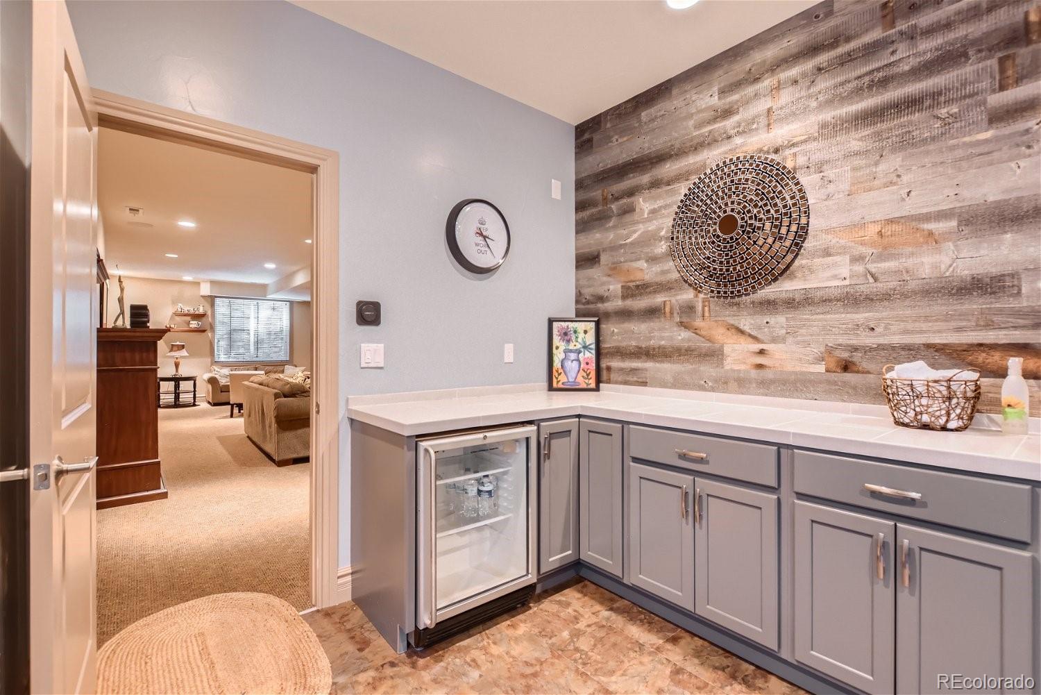 722 Skywalker Point Lafayette, CO 80026 - Photo 25 of 47 a spacious bathroom with a lot of shower furniture and a tv