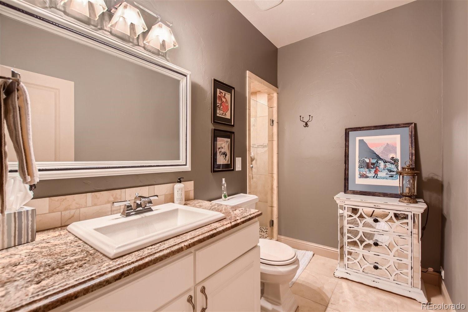 722 Skywalker Point Lafayette, CO 80026 - Photo 28 of 47 a bathroom with a granite countertop toilet sink and mirror