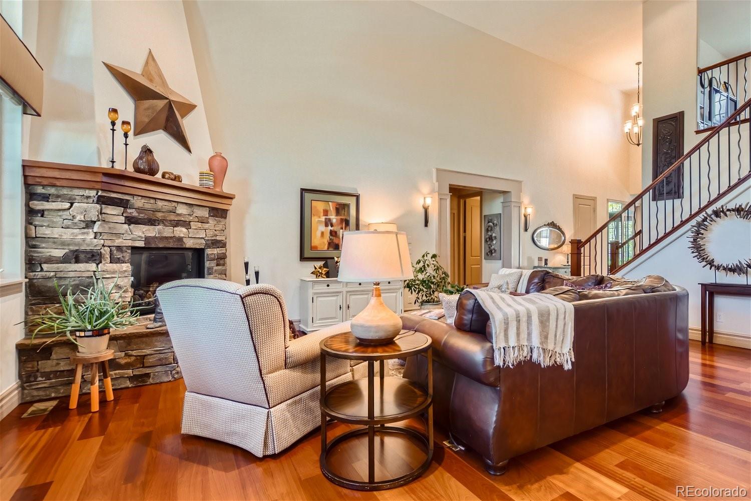 722 Skywalker Point Lafayette, CO 80026 - Photo 6 of 47 a living room with furniture a fireplace and wooden floor