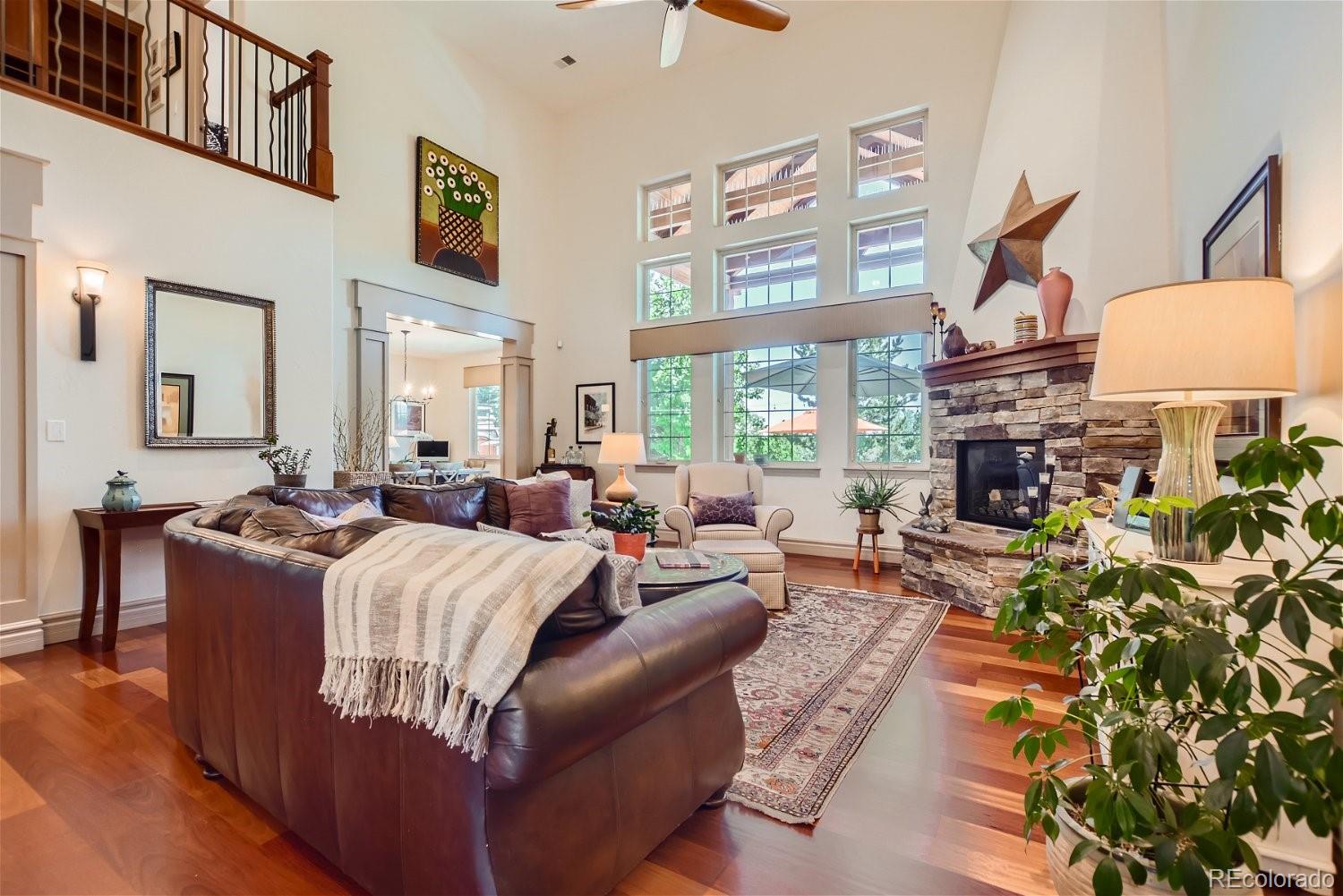 722 Skywalker Point Lafayette, CO 80026 - Photo 7 of 47 a living room with furniture a fireplace and a chandelier
