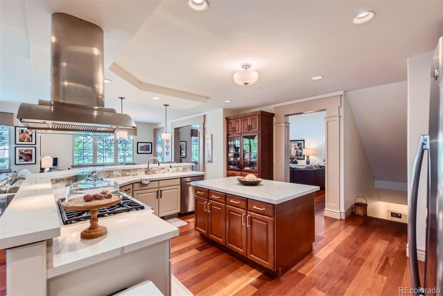 722 Skywalker Point Lafayette, CO 80026 - Photo 10 of 47 a kitchen that has a sink and a stove with wooden floor