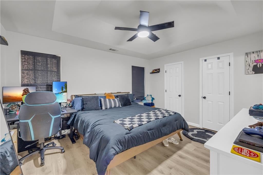 624 Red Fox Lane Auburn, GA 30011 - Photo 13 of 28 a bedroom with a bed and a chandelier