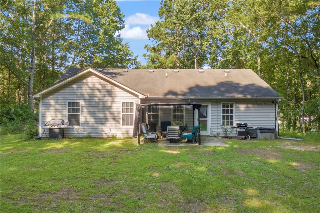 624 Red Fox Lane Auburn, GA 30011 - Photo 23 of 28 a front view of house with yard and trees in the background