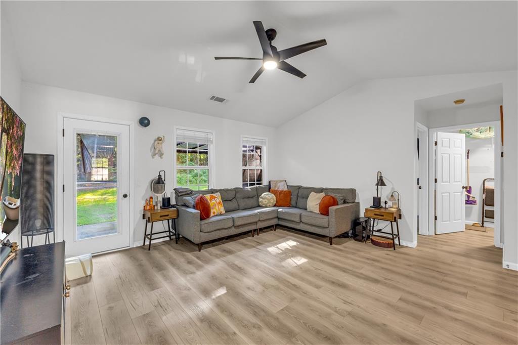 624 Red Fox Lane Auburn, GA 30011 - Photo 5 of 28 a living room with furniture and a wooden floor