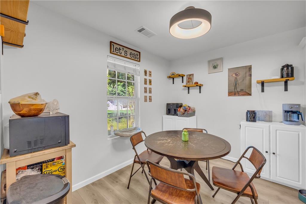 624 Red Fox Lane Auburn, GA 30011 - Photo 10 of 28 a view of a dining room with furniture and wooden floor