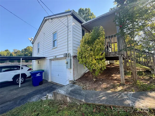 a view of backyard with table and chairs and potted plants