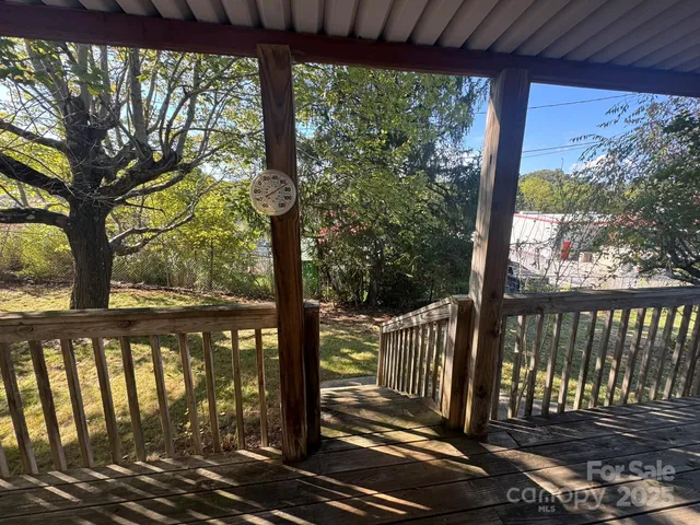 a view of a wooden deck next to a yard