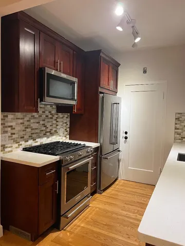 a kitchen with a stove microwave and refrigerator