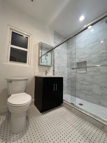 a bathroom with a sink toilet and shower