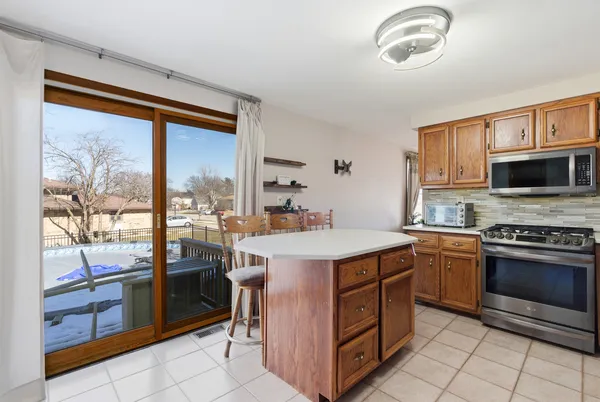 a kitchen with a stove a sink and a refrigerator