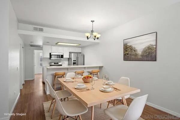 a view of a dining room with furniture and a chandelier
