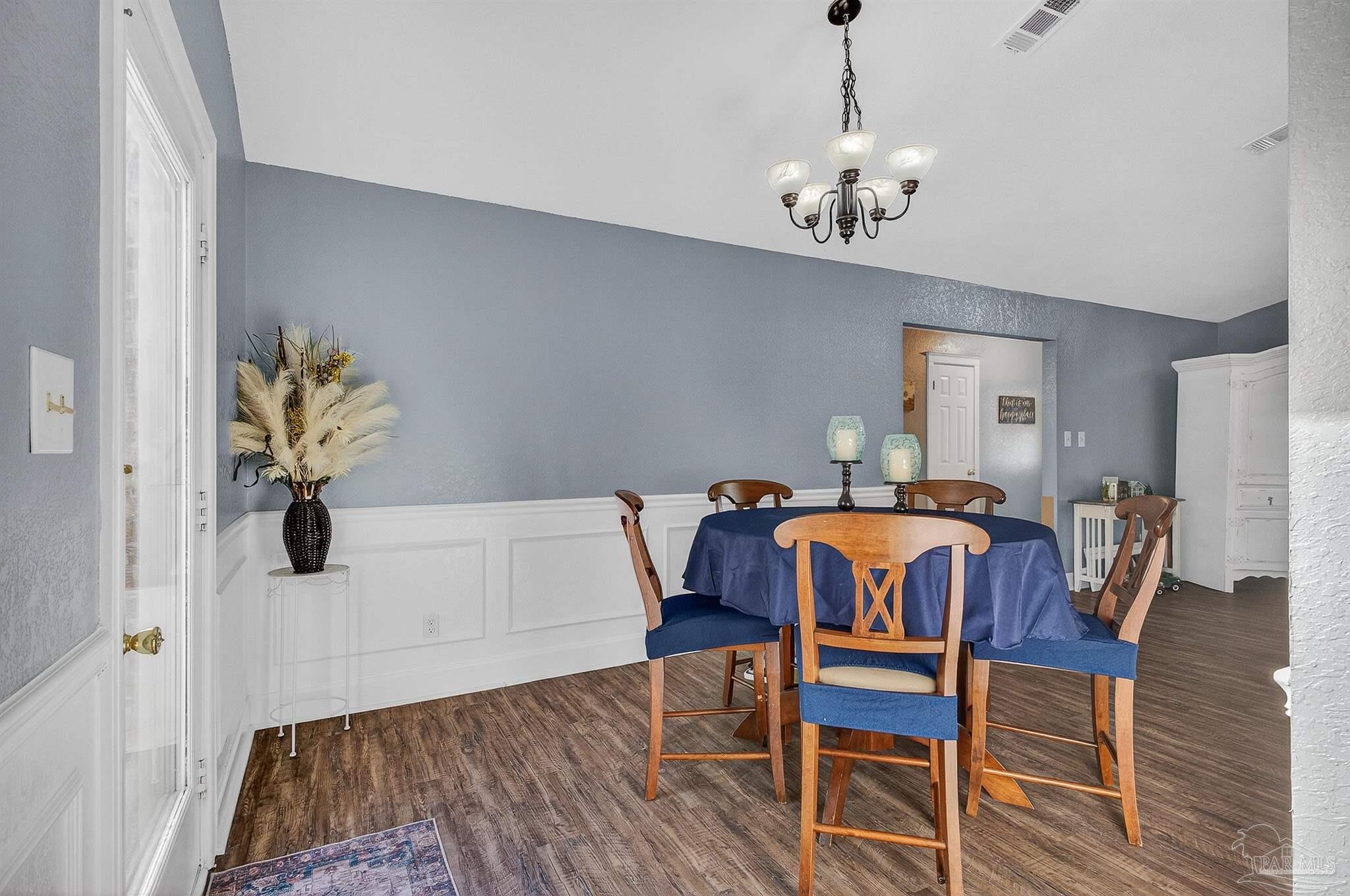 4807 Jennifer Lane Pace, FL 32571 - Photo 11 of 49 a view of a dining room with furniture and wooden floor