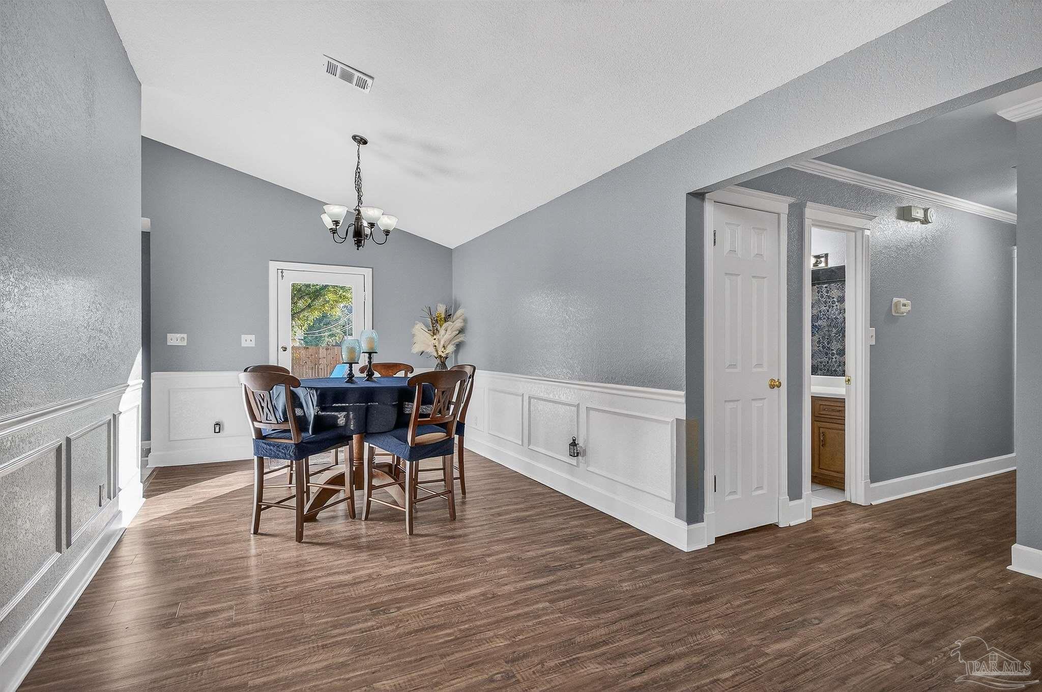 4807 Jennifer Lane Pace, FL 32571 - Photo 13 of 49 a view of a dining room with furniture and wooden floor