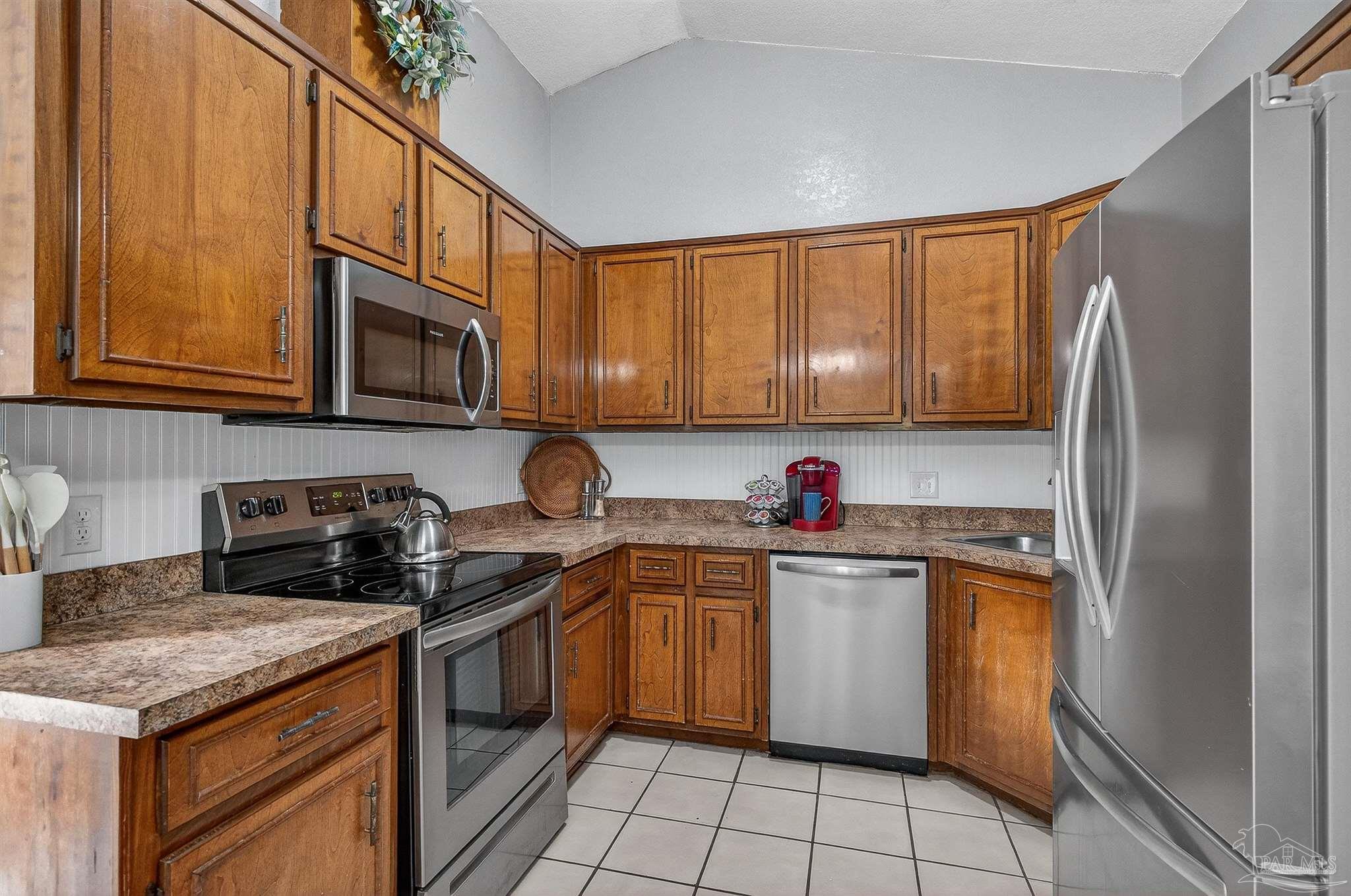 4807 Jennifer Lane Pace, FL 32571 - Photo 15 of 49 a kitchen with stainless steel appliances granite countertop a refrigerator sink and stove