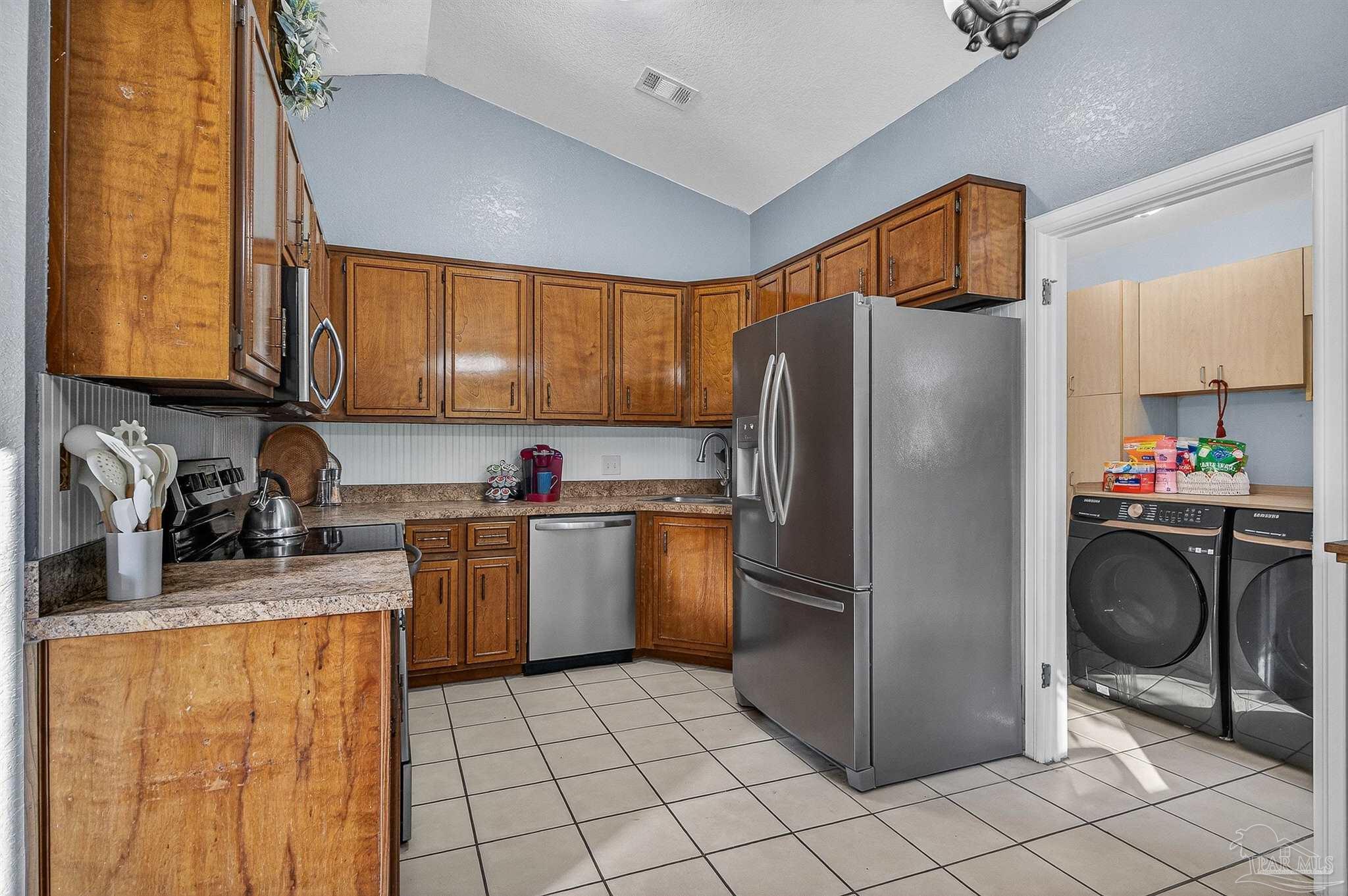 4807 Jennifer Lane Pace, FL 32571 - Photo 16 of 49 a kitchen with a refrigerator sink and cabinets