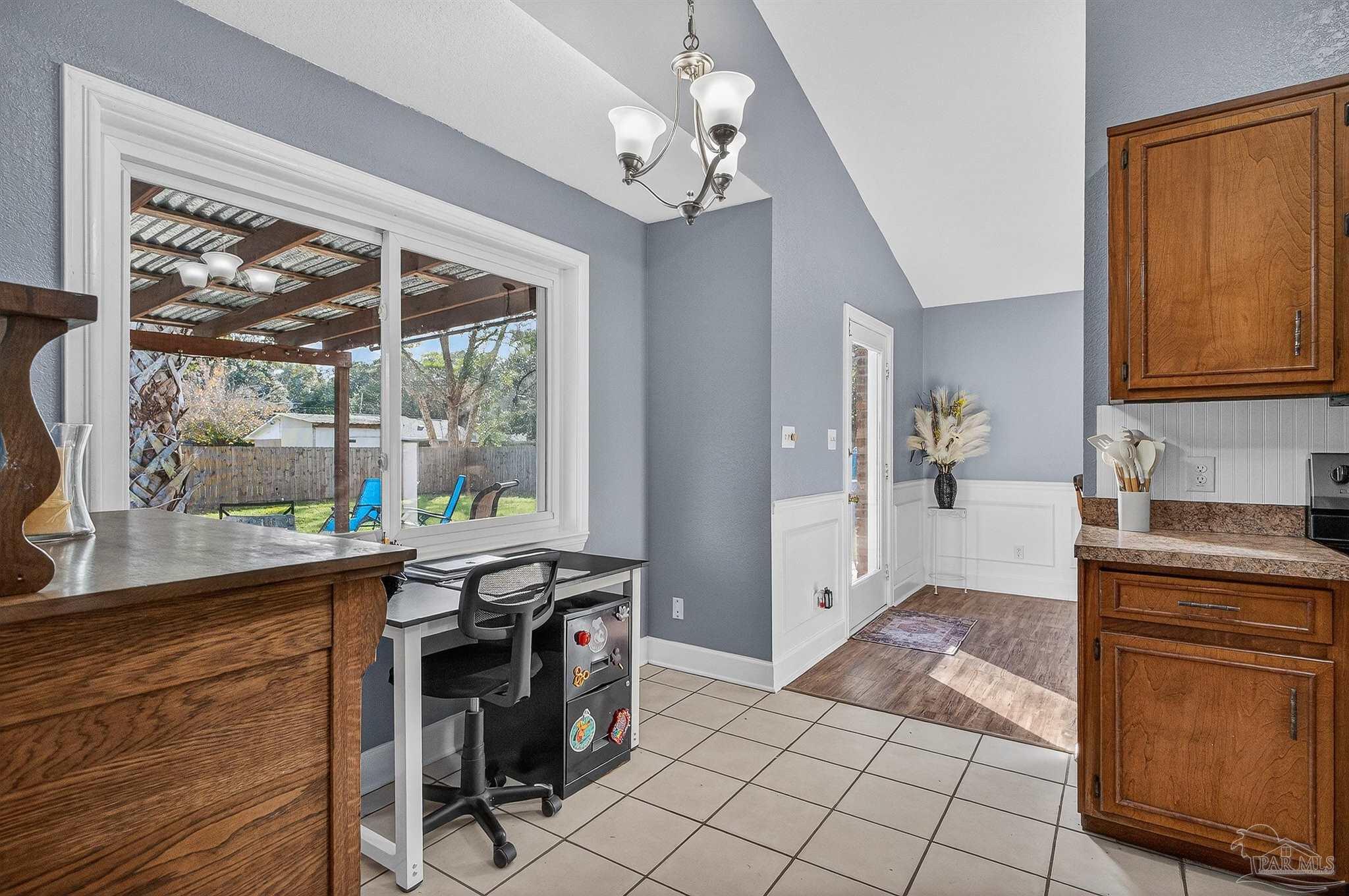 4807 Jennifer Lane Pace, FL 32571 - Photo 20 of 49 a view of a kitchen with kitchen island granite countertop a refrigerator stove top oven and sink