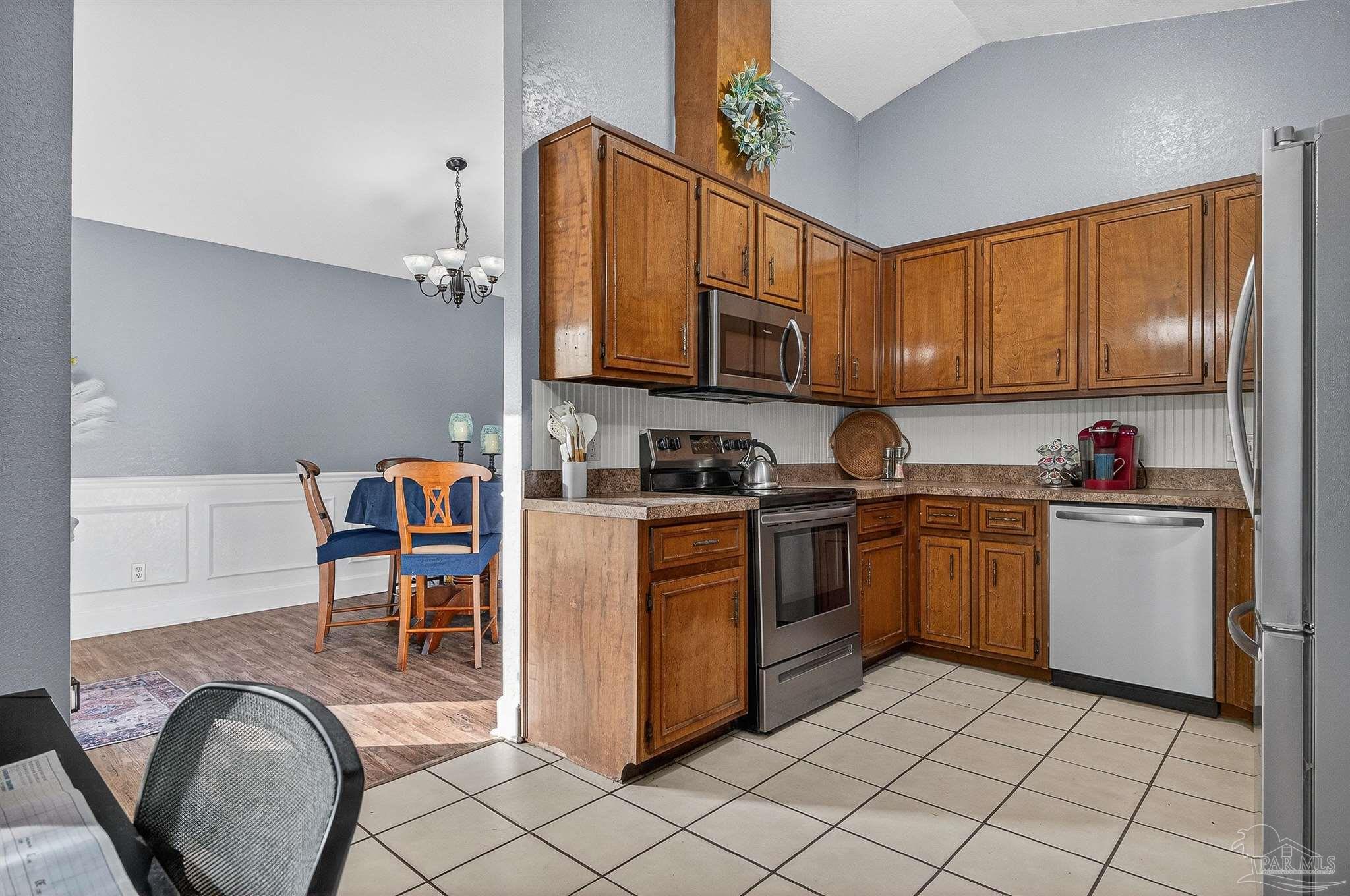 4807 Jennifer Lane Pace, FL 32571 - Photo 21 of 49 a kitchen with granite countertop a sink cabinets and stainless steel appliances