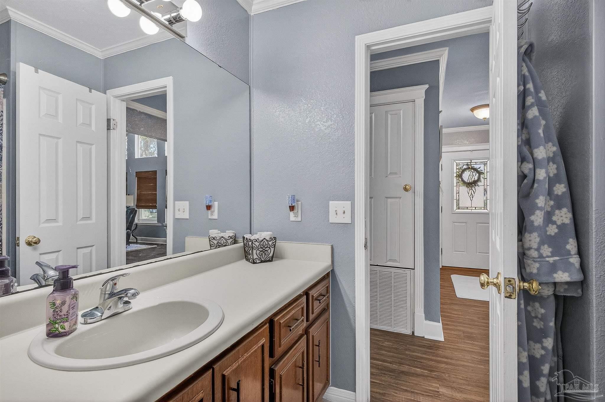 4807 Jennifer Lane Pace, FL 32571 - Photo 25 of 49 a bathroom with a sink and a mirror