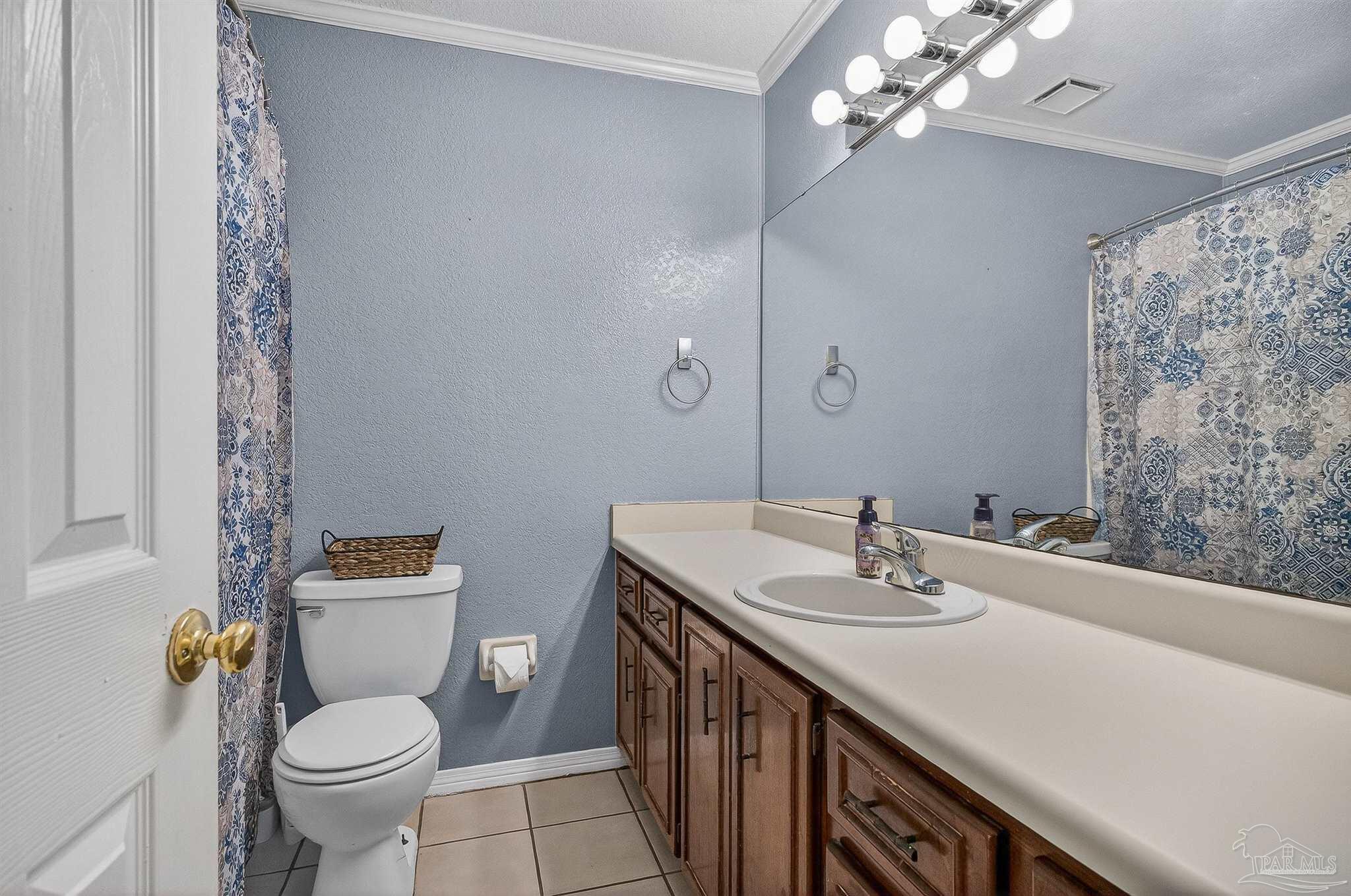 4807 Jennifer Lane Pace, FL 32571 - Photo 26 of 49 a bathroom with a sink a toilet and a mirror